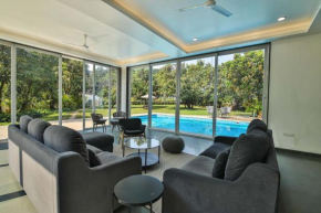 Twilight Grove by StayVista - Pool- view villa with Manicured lawn, Contemporary interiors & Home theatre